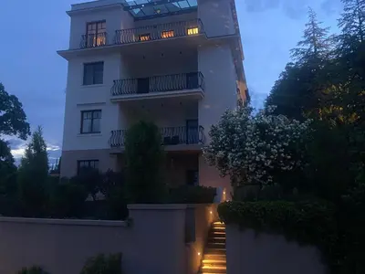 a large white building with a balcony on top at Vila Maister in Celje