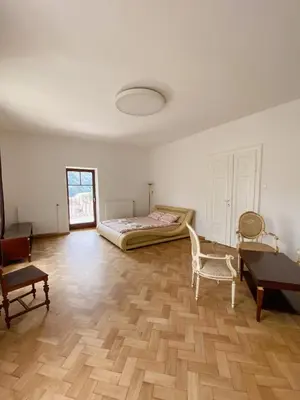 a bedroom with a bed and a chair and a desk at Vila Maister in Celje