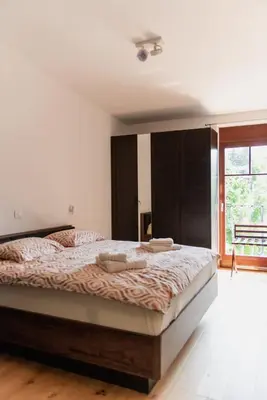 a bedroom with a large bed and a window at Vila Maister in Celje