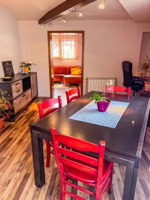 a dining room with a black table and red chairs at Marta's Place in Nova Gorica