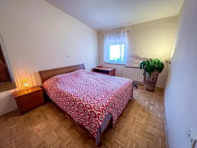 a bedroom with a bed and a potted plant at Marta's Place in Nova Gorica