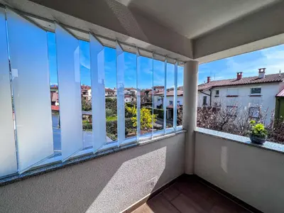 a balcony with windows with a view of the street at Marta's Place in Nova Gorica