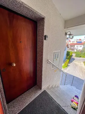 a wooden door in a building with a balcony at Marta's Place in Nova Gorica
