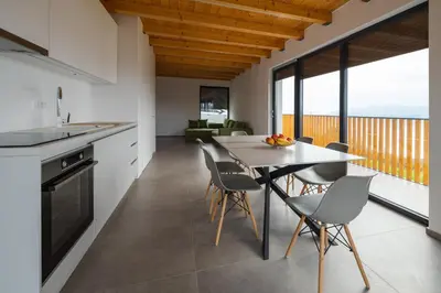 a kitchen and dining room with a table and chairs at Villa Strtenica in the vineyard in Pristava pri Mestinju