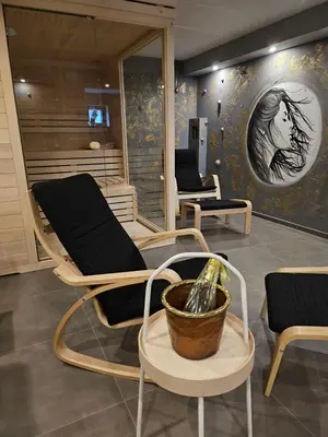 a salon with two chairs and a bath tub at Apartments & wellness Kal Koritnica in Bovec