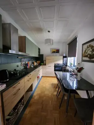 a kitchen with a table and a dining room at Apartments & wellness Kal Koritnica in Bovec