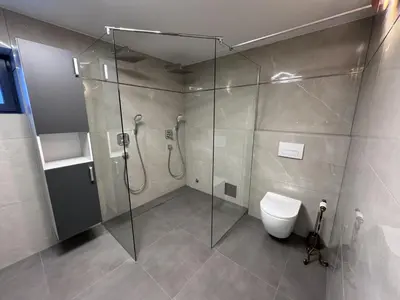 a bathroom with a glass shower and a toilet at Apartments & wellness Kal Koritnica in Bovec