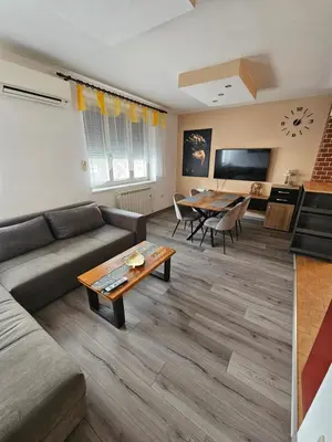 a living room with a couch and a table at SMARAGD Damir Antunovic-sobodajalec in Kobarid
