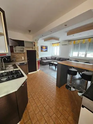 a kitchen and living room with a stove and a counter at SMARAGD Damir Antunovic-sobodajalec in Kobarid