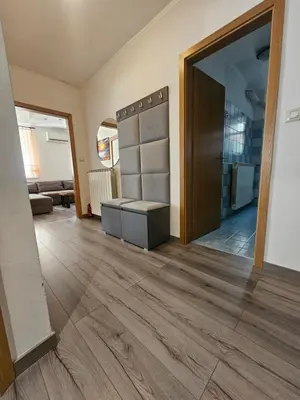 a room with wooden floors and a large mirror at SMARAGD Damir Antunovic-sobodajalec in Kobarid