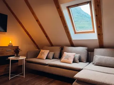 a living room with a couch and a window at Apartments Mala Korita Soče in Soča