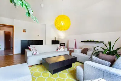 a living room with a couch and a coffee table at Farmhouse Apartment Happy Cow in Mavčiče