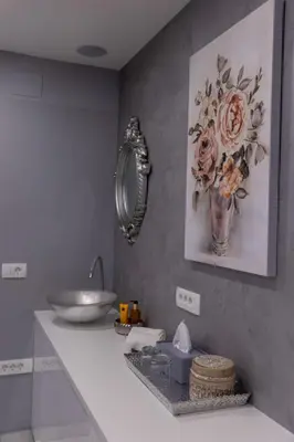 a bathroom with a sink and a vase of flowers at MM Rooms in Bled