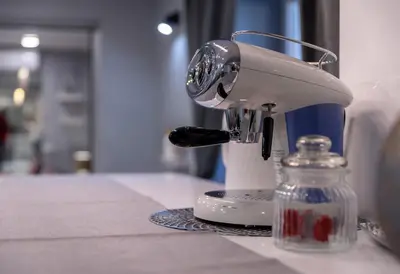 a mixer sitting on a counter next to a glass jar at MM Rooms in Bled