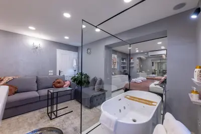 a living room with a couch and a tub at MM Rooms in Bled