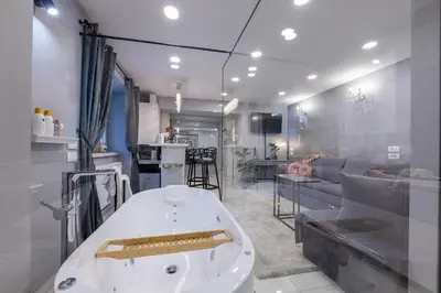 a large bath tub in a room with a couch at MM Rooms in Bled