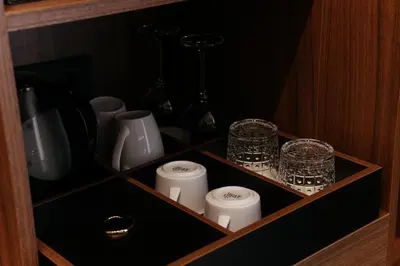 a cupboard with a row of candles and bottles at Hotel Švicarija - Terme Dobrna in Dobrna