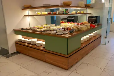 a buffet line with food on display in a restaurant at Hotel Švicarija - Terme Dobrna in Dobrna