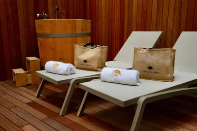 two white benches with bags on top of them at Hotel Švicarija - Terme Dobrna in Dobrna