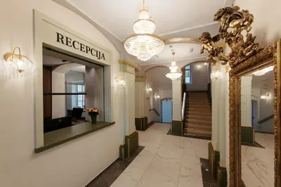 a hallway with a mirror and a staircase in a building at Hotel Švicarija - Terme Dobrna in Dobrna