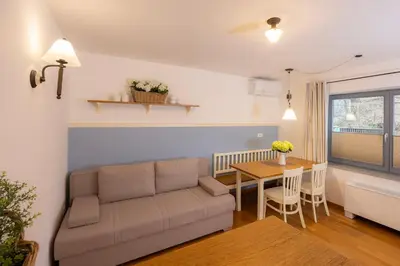 a living room with a couch and a table at Lakeside Apartments Bled in Bled