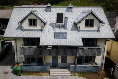 an aerial view of a house with a roof at Lakeside Apartments Bled in Bled