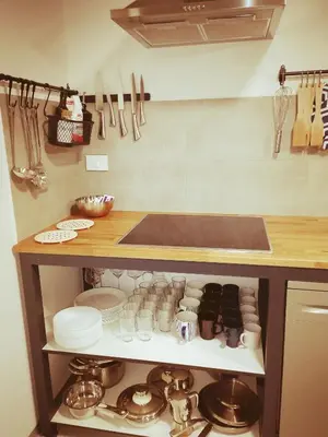 a kitchen with a counter with dishes and utensils at GARAGE HOSTEL in Nova Gorica
