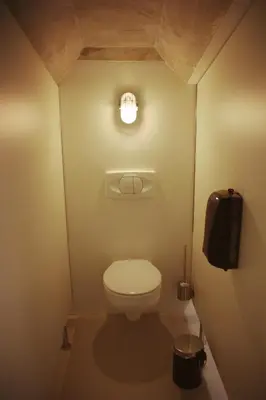 a small bathroom with a toilet and a light at GARAGE HOSTEL in Nova Gorica