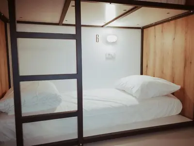 a bedroom with a bunk bed with a window at GARAGE HOSTEL in Nova Gorica
