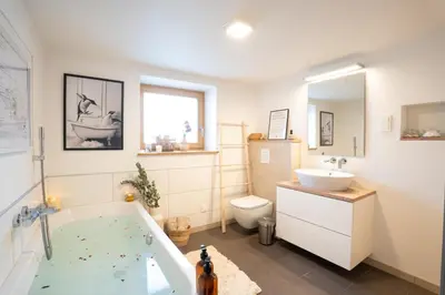 a bathroom with a tub and a sink and a toilet at Home Away From Home in Radovljica