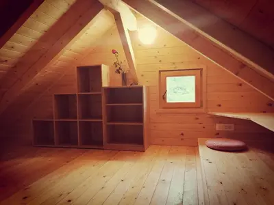 a room in a log cabin with a window at Jelenova lesena hiška in Loče pri Poljčanah