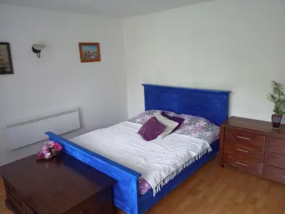 a bedroom with a blue bed and a wooden dresser at Nice Apartment near by Capital of Slovenia in Ljubljana