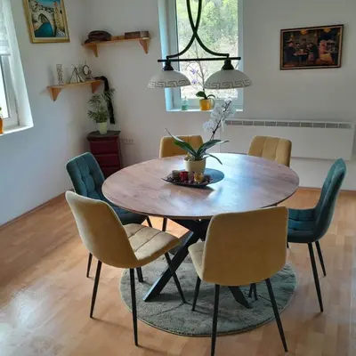 a dining room with a wooden table and chairs at Nice Apartment near by Capital of Slovenia in Ljubljana