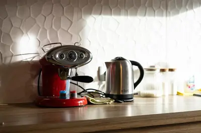 a coffee maker and a tea kettle on a counter at Central apartment great for couples or small families in Ljubljana