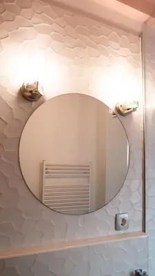 a bathroom with a large mirror on a wall at Central apartment great for couples or small families in Ljubljana