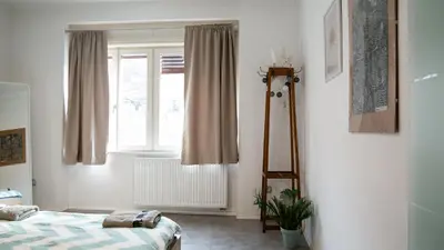 a bedroom with a bed and a window at Central apartment great for couples or small families in Ljubljana