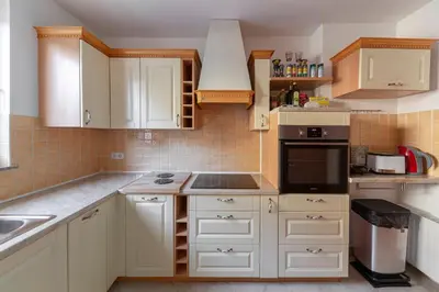 a kitchen with white cabinets and a stove top oven at Lakeview Bled Heaven Apartments in Bled