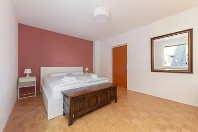 a bedroom with a bed and a table in it at Lakeview Bled Heaven Apartments in Bled