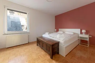a bedroom with a white bed and a window at Lakeview Bled Heaven Apartments in Bled