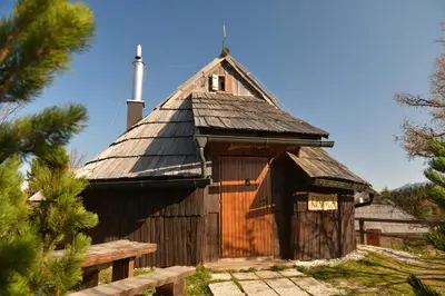 a small wooden building with a steep roof at Koča Kronca - Velika planina in Stahovica
