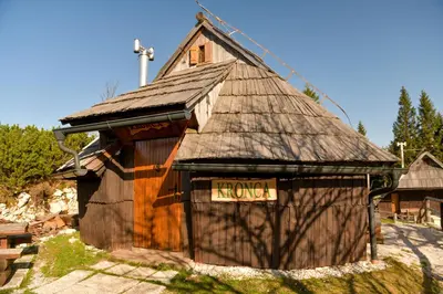 a small wooden building with a sign that reads klords at Koča Kronca - Velika planina in Stahovica