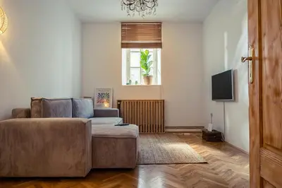 a living room with a couch and a television at Cactus apartment FREE parking for a standard car in Ljubljana
