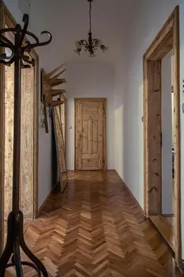 a hallway with a wooden floor and a door at Cactus apartment FREE parking for a standard car in Ljubljana