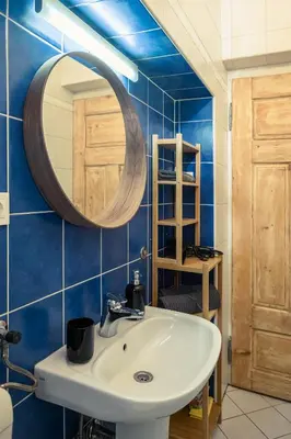 a bathroom with a sink and a mirror at Cactus apartment FREE parking for a standard car in Ljubljana