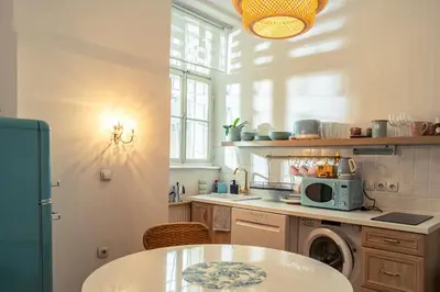a kitchen with a table and a microwave at Cactus apartment FREE parking for a standard car in Ljubljana