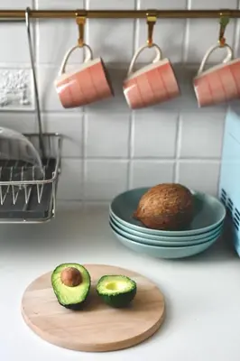 two avocado halves on a cutting board next to a plate at Cactus apartment FREE parking for a standard car in Ljubljana