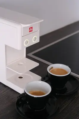 a coffee machine with two cups of coffee on a table at Apartment Kamnik-apartment with a large terrace in Kamnik