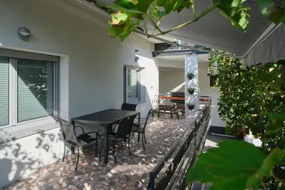 a balcony with a table and chairs on a patio at Apartment Kamnik-apartment with a large terrace in Kamnik