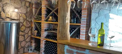 a wine cellar with wine bottles and glasses on a counter at Holiday home in Drganja sela Kranjska Krain 42002 in Drganja Sela