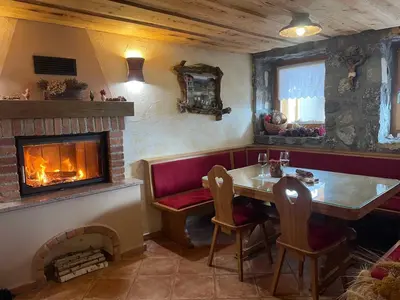 a living room with a fireplace and a table and chairs at Holiday home in Drganja sela Kranjska Krain 42002 in Drganja Sela